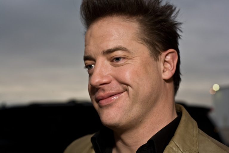Head shot of Brendan Fraser with the sky behind him